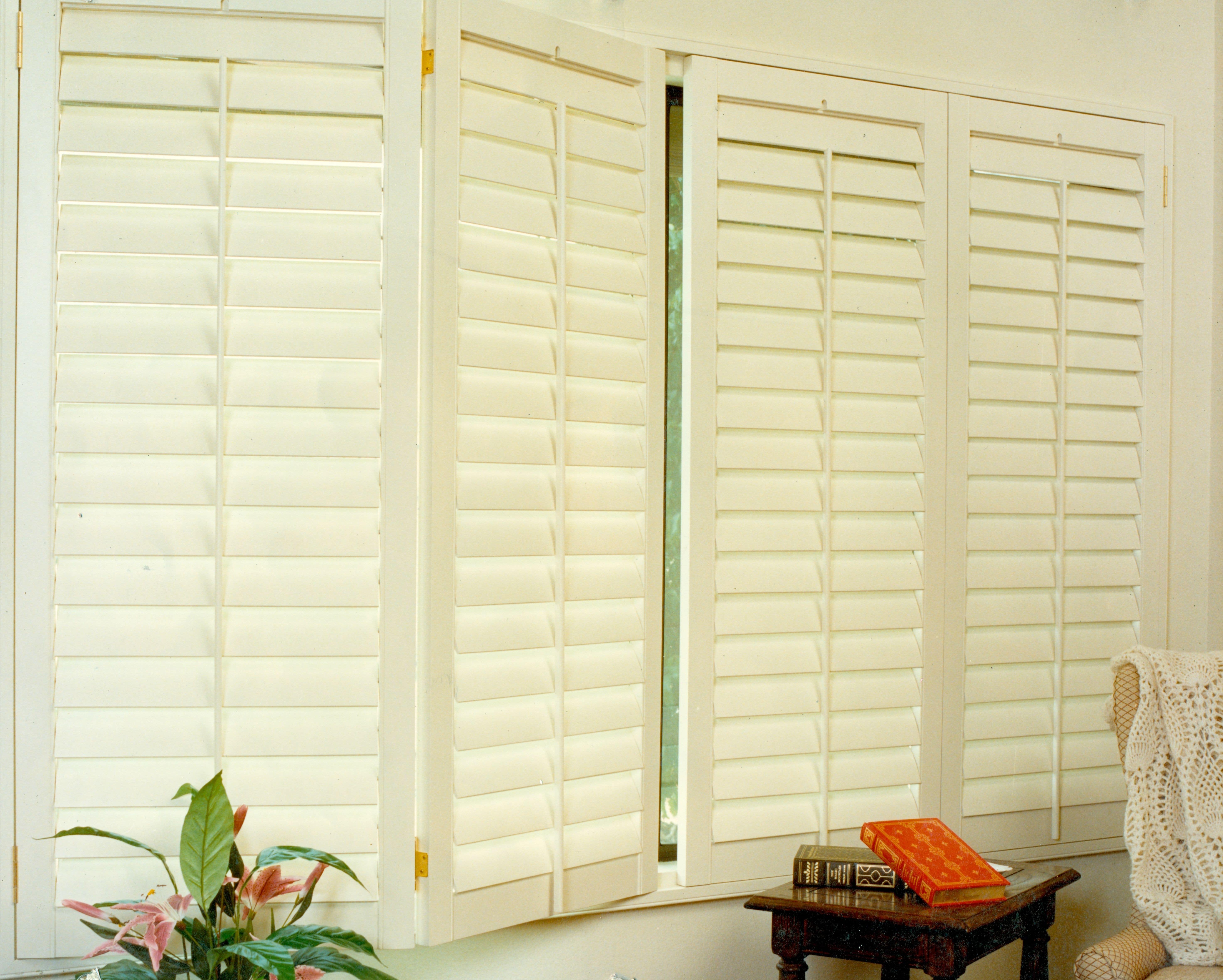 White Window Shutter Panels With Books On The Table Top