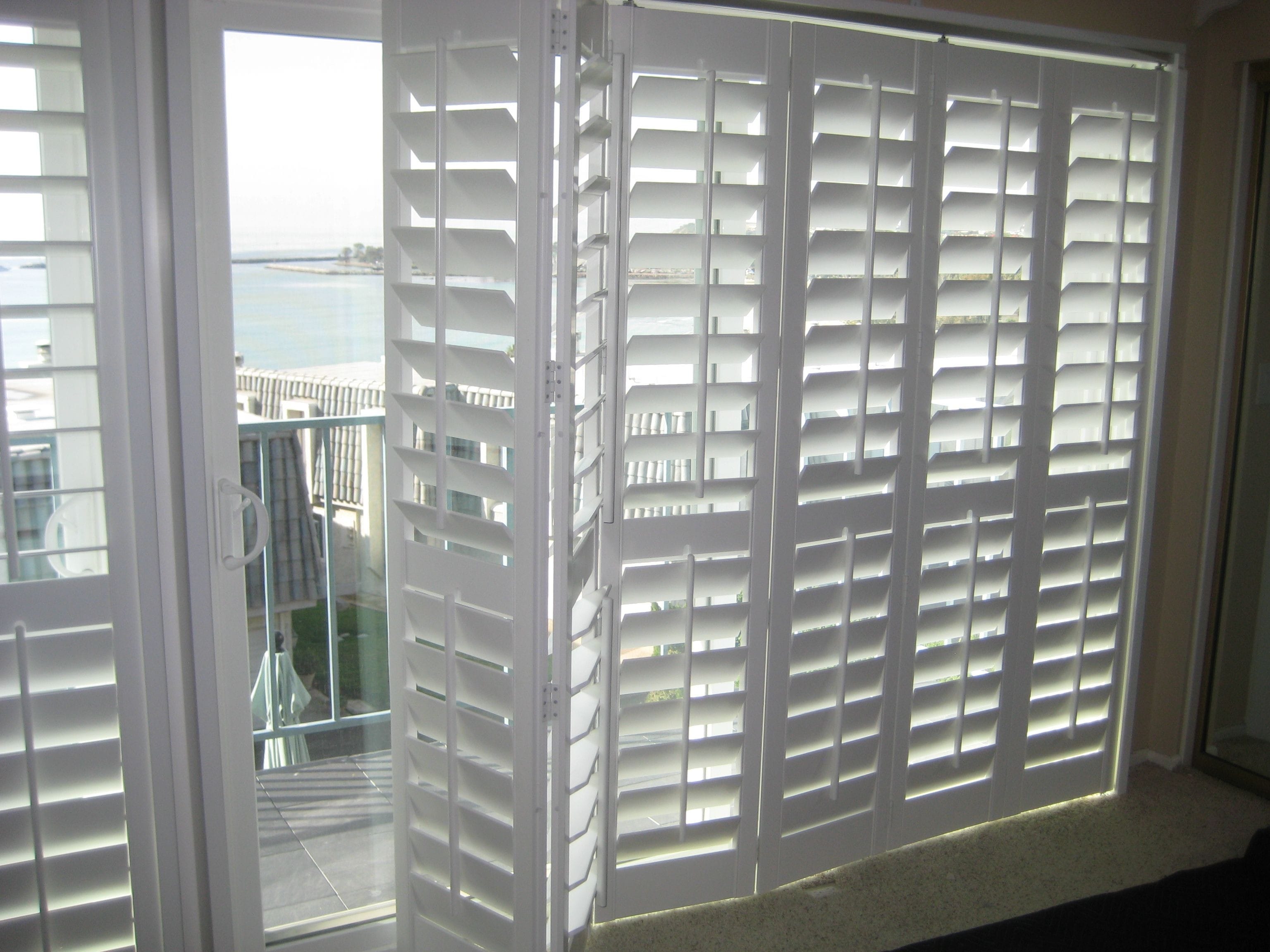 White Window Shutter With One Panel Open